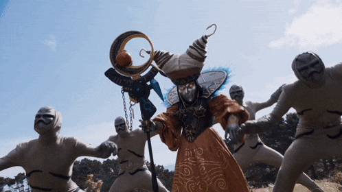 a group of people dressed in white standing around a witch
