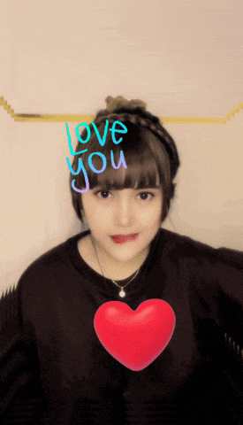 a girl with a red heart and the words love you written on her head