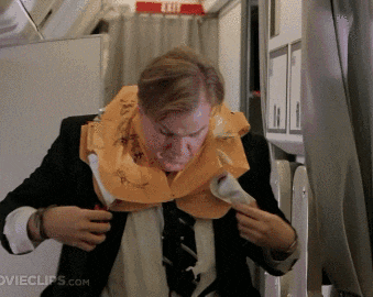 a man in a suit and tie is wearing a life preserver on his neck