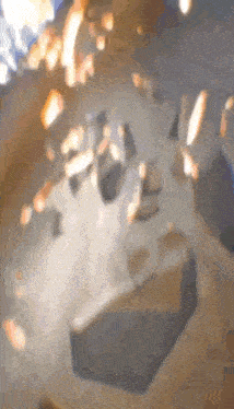 a blurred image of a brick being thrown into the air .