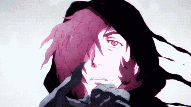 a close up of a person 's face with a black hood