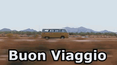 a yellow van is driving down a dirt road with the words buon viaggio written on it