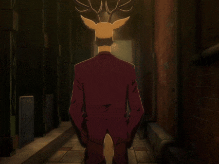 a deer with antlers is standing in a dark alley