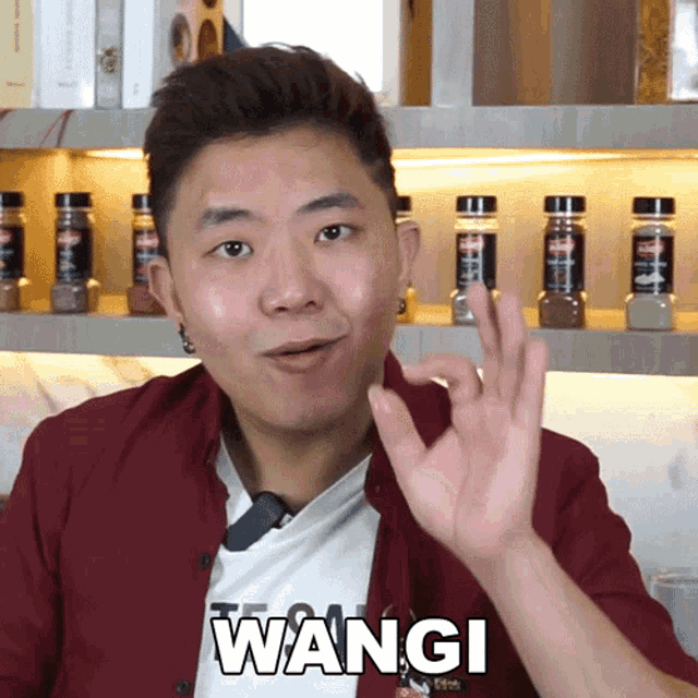a man in a red shirt with the word wangi written on his shirt