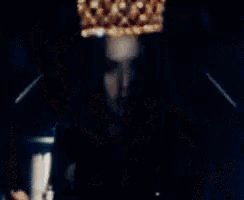 a blurry picture of a person with a crown on their head
