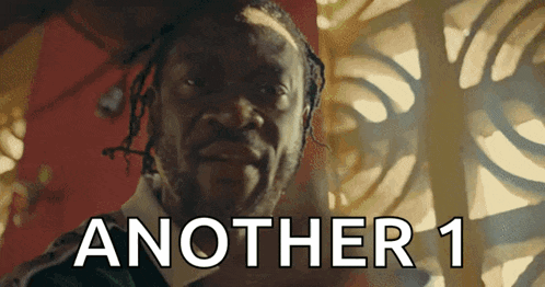 a man with dreadlocks is looking at the camera and the words another 1 are behind him