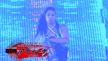 a woman is standing in front of a sign that says roh athena on it