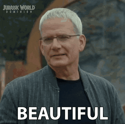 a man wearing glasses and a jacket says beautiful in a jurassic world dominion advertisement