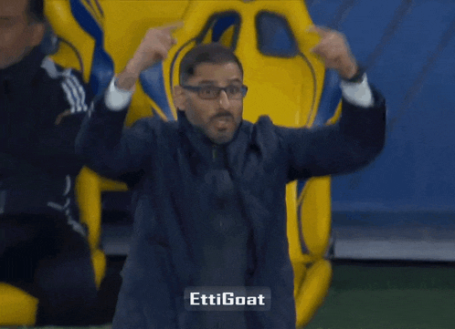 a man wearing glasses is making a funny face with the words " ettigoat " above him