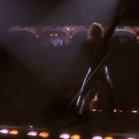 a man is standing on a stage in front of a crowd