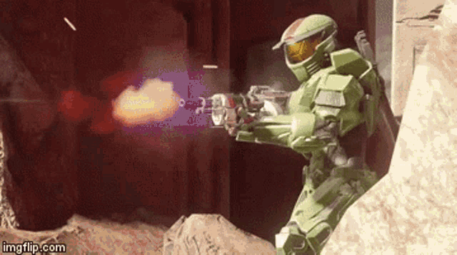 a man in a green helmet is holding a gun in a video game and the url is imgflip.com