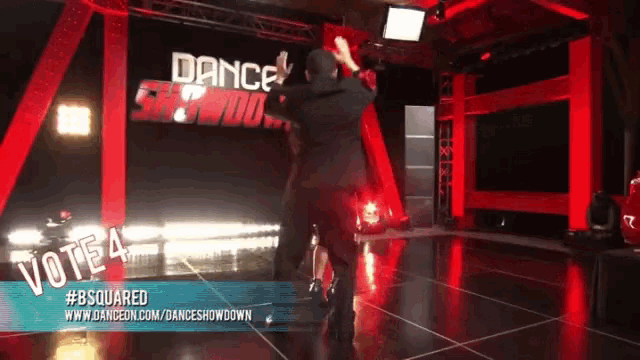a man is dancing in front of a sign that says vote 4