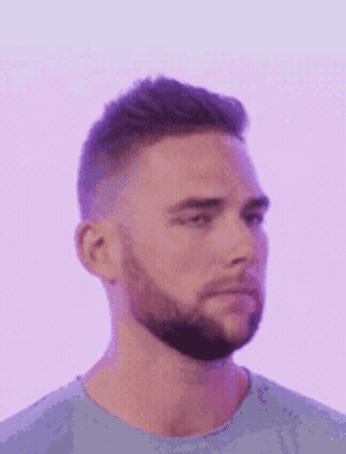 a man with a beard wearing a light blue shirt
