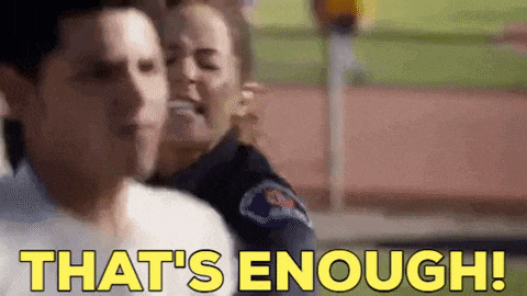 a man and a woman are standing next to each other and a police officer is saying `` that 's enough '' .