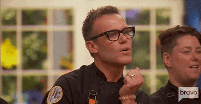 a man with glasses and a badge that says bravo
