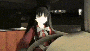 a girl in a red dress is sitting in a car