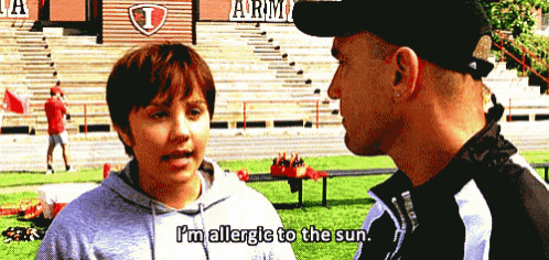 a boy talking to a man with the words i 'm allergic to the sun on his shirt