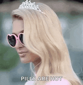 a woman wearing sunglasses , a tiara and a crown is talking about pills being hot .