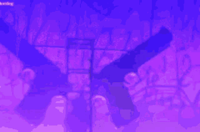 a group of people standing in front of a blue light