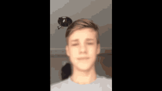 a close up of a boy 's face with a blurry background