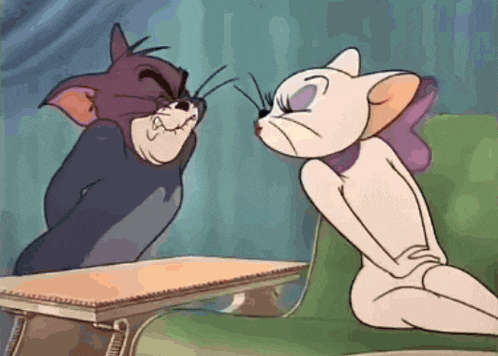 a cartoon of tom and jerry sitting next to each other on a couch