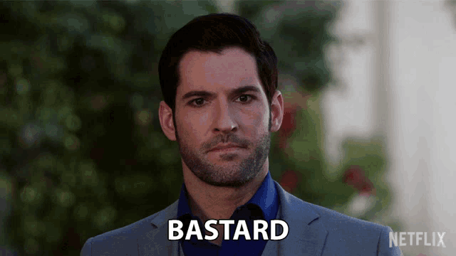 a man in a suit and blue shirt has the word bastard on his face