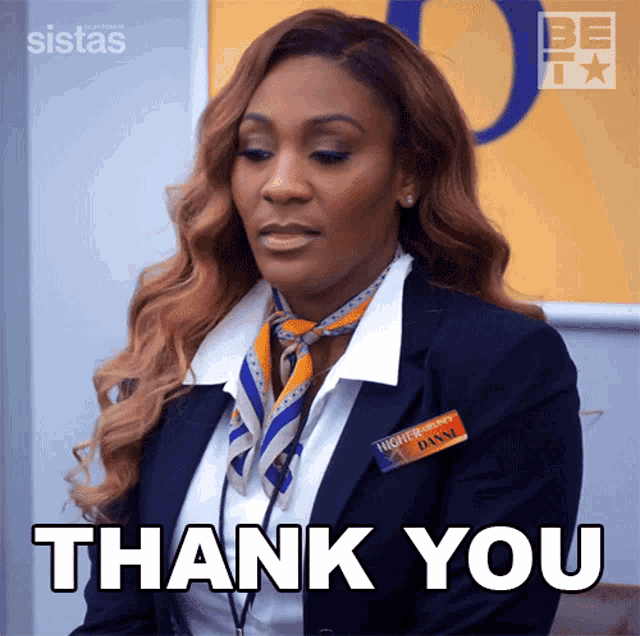 a woman in a suit says thank you in a gif