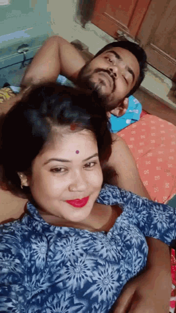 a man and a woman are posing for a picture