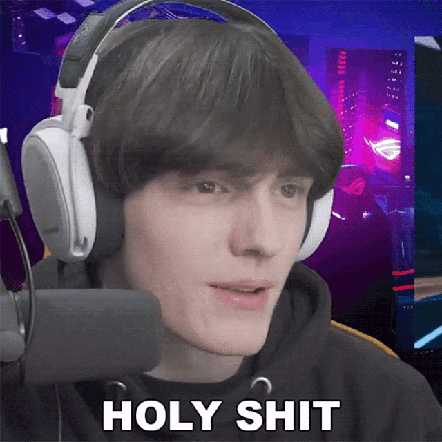 a young man wearing headphones and a black hoodie says holy shit