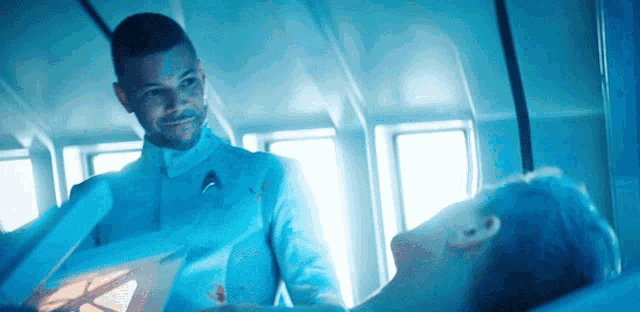 a man in a star trek uniform stands next to another man