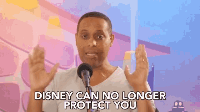 a man speaking into a microphone with the words disney can no longer protect you below him