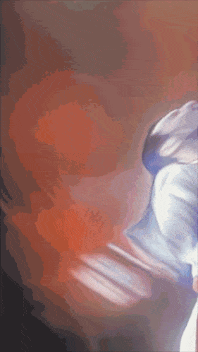 a blurred image of a person 's face with a red and orange background
