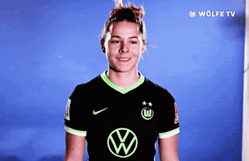 a woman wearing a black shirt with a vw logo