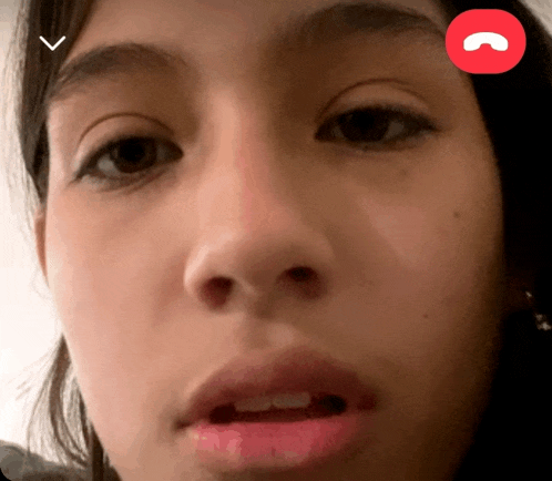 a close up of a girl 's face with a red circle in the corner that says ' call '