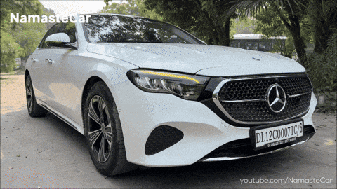 a white mercedes with a license plate that says dl12c0007tc