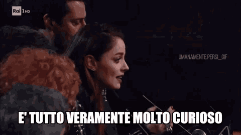 a woman says e ' tutto veramente molto curioso in front of a microphone