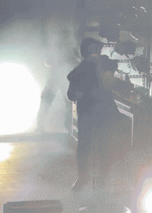 a pixelated image of a man standing in front of a smoke filled room