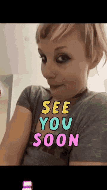a woman wearing a shirt that says " see you soon "