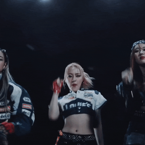 a woman wearing a crop top that says ' infinite ' on it is dancing