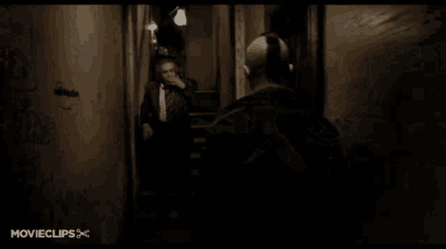 a man in a suit and tie is giving the middle finger in a movie clip from movieclips