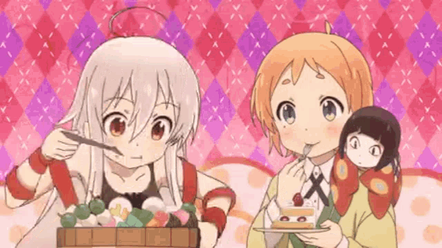 two anime girls are eating a cake and holding a doll in their arms .