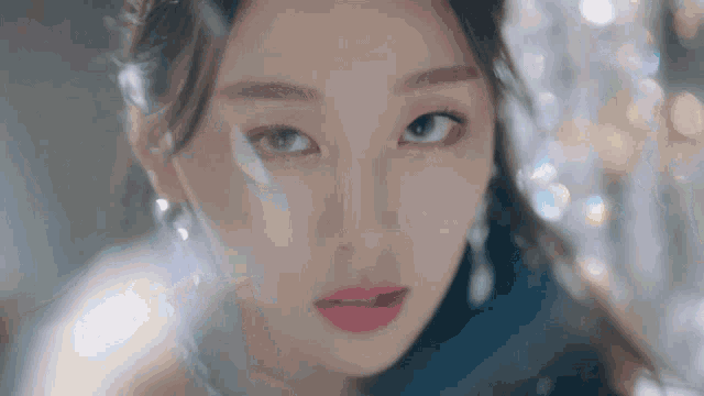 a close up of a woman 's face with a blurry background