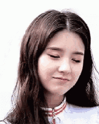 a close up of a woman 's face with her eyes closed and a smile on her face .