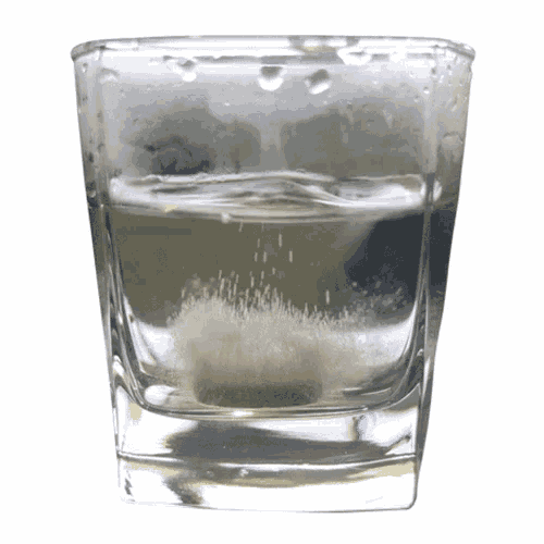 a glass of water with bubbles on the surface