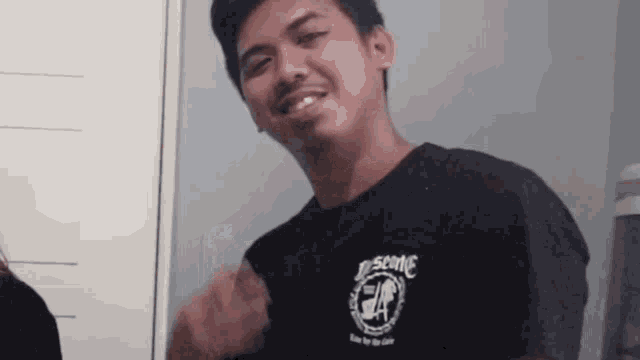 a young man wearing a black shirt that says ea