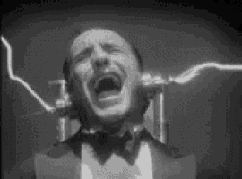 a man in a tuxedo and bow tie is screaming in front of a lightning bolt in a black and white photo .