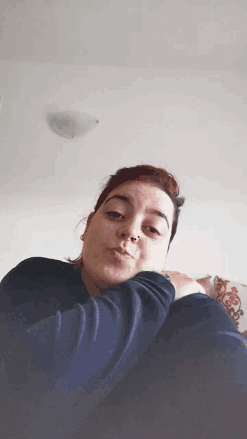 a woman with red hair is making a funny face