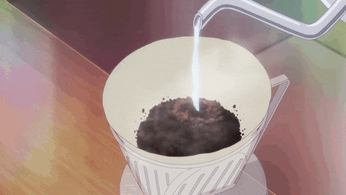 a cup of coffee is being poured into a coffee filter