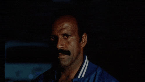 a person in a blue jacket with white stripes on the sleeves