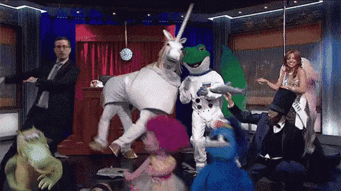 a group of people dressed up in costumes including a unicorn and frog